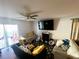Spacious living room featuring a large TV and comfortable seating at 3316 Thistledown Ln, Land O Lakes, FL 34638
