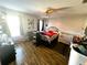 Bedroom with double bed and crib, wood flooring at 3316 Thistledown Ln, Land O Lakes, FL 34638