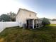 Backyard with screened patio, landscaping and fence at 3316 Thistledown Ln, Land O Lakes, FL 34638