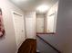 Upstairs hallway with doors to bedrooms and linen closet at 3316 Thistledown Ln, Land O Lakes, FL 34638
