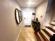 Bright entryway with tile flooring, mirrors, and staircase at 3316 Thistledown Ln, Land O Lakes, FL 34638