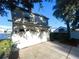 Two-car garage with driveway and landscaping at 3316 Thistledown Ln, Land O Lakes, FL 34638
