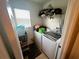 Laundry room with washer, dryer, and shelving at 3316 Thistledown Ln, Land O Lakes, FL 34638