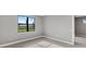 Clean bedroom featuring tile floors, neutral paint, a large window, and natural light creating an airy atmosphere at 4717 Blue Star Ct, North Port, FL 34289