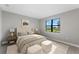Relaxing main bedroom with plush carpeting, natural light, and stylish decor, creating a cozy atmosphere at 4717 Blue Star Ct, North Port, FL 34289