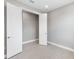 Bright bedroom with gray walls, wood-look floors, and double doors at 4717 Blue Star Ct, North Port, FL 34289