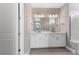 Bright bathroom featuring double sinks and a large mirror at 4717 Blue Star Ct, North Port, FL 34289
