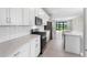 Modern kitchen with white cabinets, quartz countertops and stainless steel appliances at 4717 Blue Star Ct, North Port, FL 34289