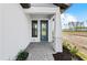 Modern front entry with a gray door, gray pavers, and landscaping at 4717 Blue Star Ct, North Port, FL 34289