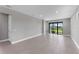 Bright living room with tile floors and sliding glass doors leading to a lanai at 4717 Blue Star Ct, North Port, FL 34289