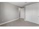 Spacious bedroom with gray walls, wood-look floors, and double doors to closet at 4717 Blue Star Ct, North Port, FL 34289