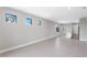 Open and bright living room with tile flooring and multiple windows at 4717 Blue Star Ct, North Port, FL 34289