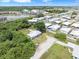 An aerial view of a quaint home with surrounding greenery and other homes in the community at 801 Brodhag Dr, Punta Gorda, FL 33950