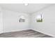Clean, neutral bedroom with two bright windows and modern flooring at 801 Brodhag Dr, Punta Gorda, FL 33950