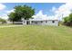 Single-story home featuring a well-maintained yard and white exterior at 801 Brodhag Dr, Punta Gorda, FL 33950