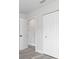 Bright hallway featuring modern gray flooring, white trim and doors, including a bifold closet at 801 Brodhag Dr, Punta Gorda, FL 33950