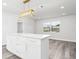 Modern kitchen island featuring white countertops and gold hardware accents at 801 Brodhag Dr, Punta Gorda, FL 33950