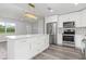 Bright kitchen featuring a large island, stainless steel appliances, and modern fixtures at 801 Brodhag Dr, Punta Gorda, FL 33950
