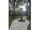 Curved walkway leads to charming house exterior, surrounded by trees at 10520 Henderson Rd, Tampa, FL 33625