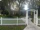 House exterior with white picket fence and landscaped yard at 10520 Henderson Rd, Tampa, FL 33625