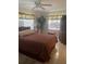 Bedroom with double bed, ceiling fan, and dresser at 90 144Th Ave # 7, Madeira Beach, FL 33708