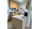 Small kitchen with light-colored cabinets and appliances at 90 144Th Ave # 7, Madeira Beach, FL 33708