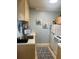 Small galley kitchen with white appliances and light wood cabinets at 90 144Th Ave # 7, Madeira Beach, FL 33708
