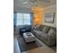 Living room with sofa, chair, ottoman and large window at 90 144Th Ave # 7, Madeira Beach, FL 33708