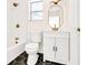 Updated bathroom features white hex tile, gold fixtures, and a white vanity at 1207 E 17Th Ave, Tampa, FL 33605