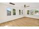 Bright bedroom with hardwood floors, multiple windows, and ceiling fan at 1207 E 17Th Ave, Tampa, FL 33605