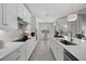 White kitchen with center island, stainless steel appliances, and breakfast nook at 13576 Boatbill Ln, Port Charlotte, FL 33981