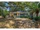 Ranch style home with mature landscaping and large shade trees at 16637 Livingston Ave, Lutz, FL 33559