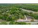 Aerial view showing home on wooded lot near highway at 16637 Livingston Ave, Lutz, FL 33559