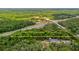 Aerial view of a spacious lot, bordered by a highway and greenery at 16637 Livingston Ave, Lutz, FL 33559
