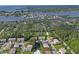 Aerial view of waterfront property with community pool and lush landscaping at 7720 Sailwinds Pass, Port Richey, FL 34668
