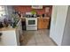 Kitchen with wood cabinets, tile floor and appliances at 2905 W Osborne Ave, Tampa, FL 33614