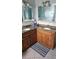 Bathroom with double sinks, granite countertops, and tile floors at 2905 W Osborne Ave, Tampa, FL 33614