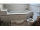 Bathroom with built-in bathtub, tile floors, and a step-in shower at 2905 W Osborne Ave, Tampa, FL 33614