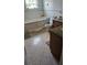 Bathroom with tile floors, built-in bathtub, and granite vanity at 2905 W Osborne Ave, Tampa, FL 33614