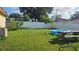 Backyard with grassy area, pool, and picnic table at 2905 W Osborne Ave, Tampa, FL 33614
