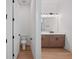 Bright bathroom with toilet visible from doorway, and a view of the double sink vanity with frameless mirror at 8320 Golden Beach Ct, Parrish, FL 34219