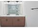 Modern bathroom featuring a double sink vanity, framed mirror and a tiled walk-in shower at 8320 Golden Beach Ct, Parrish, FL 34219