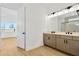 Modern bathroom with double vanity and view into bedroom at 8320 Golden Beach Ct, Parrish, FL 34219