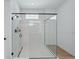 Modern bathroom with glass enclosed walk-in shower with multiple shower heads and a view from the window at 8320 Golden Beach Ct, Parrish, FL 34219