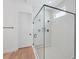 Modern bathroom with white tiled walk-in shower featuring a frameless glass enclosure and modern fixtures at 8320 Golden Beach Ct, Parrish, FL 34219