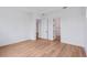 Bright bedroom featuring light wood floors, white walls and trim, and 2 doorways leading to other spaces at 8320 Golden Beach Ct, Parrish, FL 34219