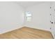 Simple bedroom with light wood flooring and a window at 8320 Golden Beach Ct, Parrish, FL 34219