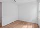 Neutral bedroom with wood grain flooring and white walls at 8320 Golden Beach Ct, Parrish, FL 34219