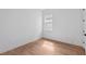Bright bedroom with wood grain flooring and a window that lets in natural light at 8320 Golden Beach Ct, Parrish, FL 34219
