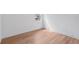 Bright bedroom with a street view window, white walls, and wood grain flooring at 8320 Golden Beach Ct, Parrish, FL 34219